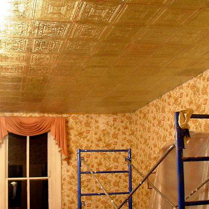 Gilded Armstrong ceiling tile being installed